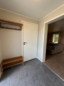 an empty room with a door and a couch at Rest and Stay in Piteå