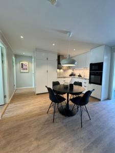 a kitchen and dining room with a table and chairs at Rest and Stay in Piteå