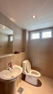 a bathroom with a toilet and a sink at Seaview Condominium A12 in Ban Tha Fat +15 photos