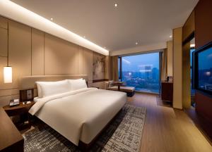 Postel nebo postele na pokoji v ubytování Maison New Century Hotel Cixi Hangzhou Bay