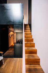 a stairway leading up to a kitchen and a kitchen at Libertine Lindenberg in Frankfurt/Main