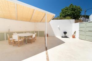 a kitchen and dining room with a table on a patio at Casa Lluminosa, fabulosa y moderna casa de pueblo by Sonne Villas in Ferreries