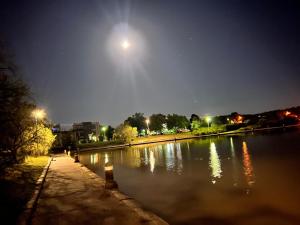 a moon over a body of water at night at The Lakes Homestead - Shared House in Mill Park +3 photos