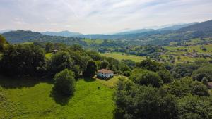an aerial view of a small house on a green field at Casa Rural La Santa in Sorribas