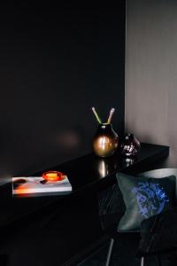 a black table with a vase on top of it at Libertine Lindenberg in Frankfurt/Main