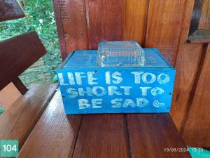 a blue box that says life is too short to be sad at Horizon Resort in Ko Samed