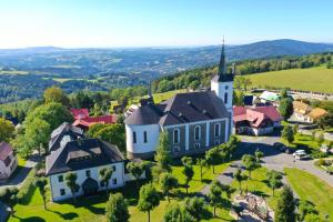 an aerial view of a small village with a church at Chata u kostela in Kořenov