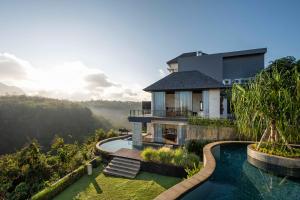 an aerial view of a house with a swimming pool at By The Cliff Bali Villa in Jimbaran