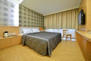 Postel nebo postele na pokoji v ubytování Ing Wang Hotel