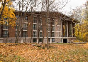 a building with a pile of leaves in front of it at Pokoje Gościnne Białowieskiego Parku Narodowego, Białowieża in Białowieża