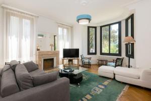 a living room with a couch and a fireplace at Belle villa savoyarde typique Lac 4 mn à pied in Annecy
