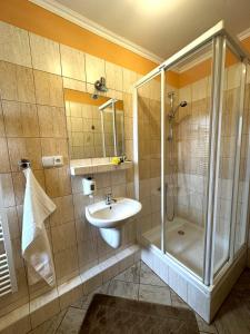a bathroom with a shower and a sink at Suita - dvojposteľová izba in Veľká Lomnica