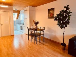 a dining room with a table and a potted plant at City Vibe Apartment in Bümpliz