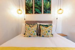 a bedroom with a white bed with pillows at Luxurious Large Townhouse in the Heart of Barbican in Plymouth