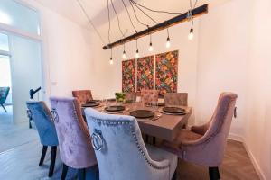 a dining room with a table and chairs at Luxurious Large Townhouse in the Heart of Barbican in Plymouth