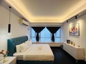 a bedroom with a large bed and a window at R&F Seine Region at ANJU in Johor Bahru