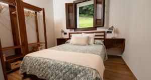 ein Schlafzimmer mit einem Bett und einem Fenster in der Unterkunft La casina de Peñaullan in Pravia