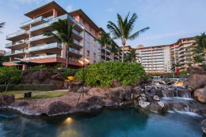 a resort with a waterfall and a hotel at Honua Kai Konea 204 in Kahana