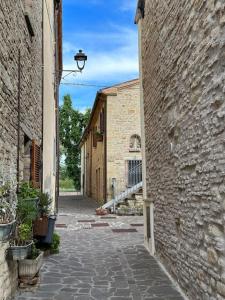 an alley between two buildings with a street light at Bellissimo borgo Medioevale Panorama, Tranquillità in SantʼIppolito +48 photos