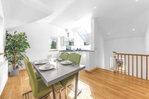 a dining room with a table and green chairs at Forge Bridge House Coniston in Coniston