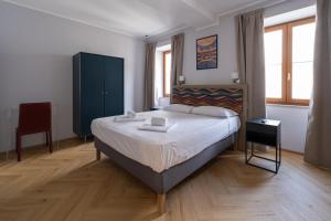 a bedroom with a large bed with white sheets at 23 Suites in Trieste