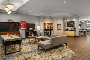 a living room with a couch and a table at TownePlace Suites by Marriott Salt Lake City-West Valley in West Valley City