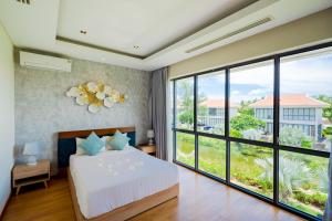 Postel nebo postele na pokoji v ubytování Asana Ocean Resort & Spa Danang + 37 fotografií