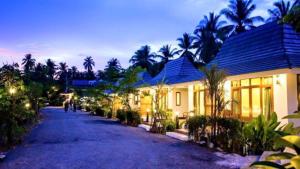 una casa con una carretera frente a un edificio en Ruean Thai Nai Bang by PANSAK Resort en Surat Thani