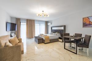 a bedroom with a bed and a living room at Katowice Apartamenty Hetmańska 4 in Katowice