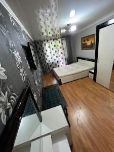 a room with two beds and a wall with graffiti at Rent&Live large apartment in Chişinău