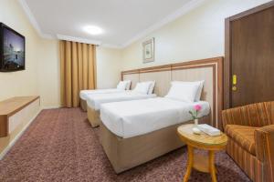 Postel nebo postele na pokoji v ubytování Palestine Hotel Makkah