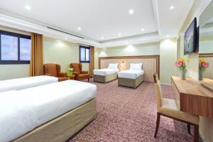 Postel nebo postele na pokoji v ubytování Palestine Hotel Makkah