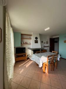 a living room with a table and a dining room at Casetta bella vista in Aviatico +23 photos