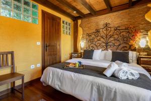 a bedroom with a large bed with towels on it at El Llosín in Ribadesella