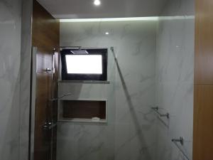 a bathroom with a shower with a television on the wall at La Juanita Bis in Praia