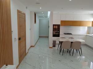 a kitchen with a table and chairs in a room at La Juanita Bis in Praia
