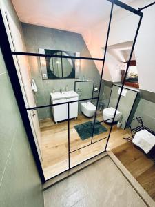 a bathroom with two toilets and a sink at Casa Mugur in Sinaia