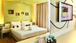 Ein Bett oder Betten in einem Zimmer der Unterkunft A-Te Chumphon Hotel - SHA Plus
