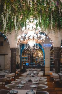 a large dining room with tables and a chandelier at Bayazhan Hotel ve Restaurant in Gaziantep