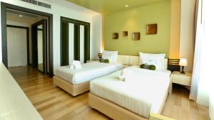 Ein Bett oder Betten in einem Zimmer der Unterkunft A-Te Chumphon Hotel - SHA Plus