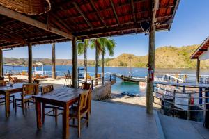 un ristorante con vista sull'acqua e su una barca di Pousada Piratas do Barro Branco a Pedregulho