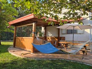eine Hängematte auf einer Terrasse mit einem Tisch und einem Sonnenschirm in der Unterkunft Home & Garden in Castel di Sangro