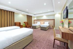 Postel nebo postele na pokoji v ubytování Palestine Hotel Makkah