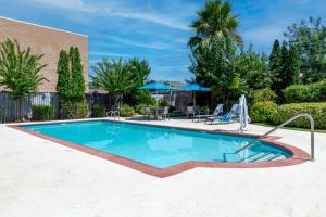 a swimming pool with blue water in a yard at Hampton Inn & Suites Sacramento-Auburn Boulevard in Sacramento