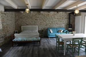 a living room with a couch and a table at La Casetta Agriturismo in Santa Sofia