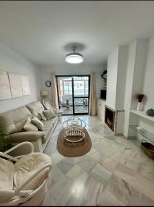 a living room with a couch and a table at Apto Laguna con piscina in El Portil