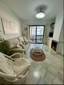 a living room with a couch and a table at Apto Laguna con piscina in El Portil