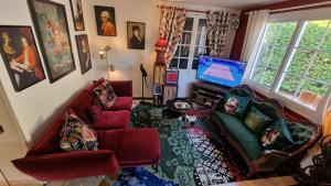 a living room with two couches and a television at Hôtel Saint Jacques in Thorigné-sur-Dué