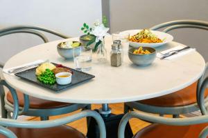 a white table with plates of food on it at Best Western Plus Park City Solna in Solna