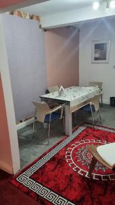 a room with a table and chairs and a rug at Apartment 3 in Leicester